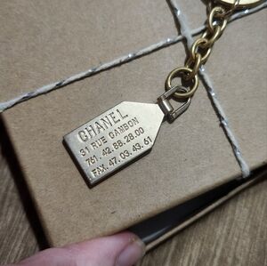 Repurposed CHANEL zipper pull on keyring with chain.